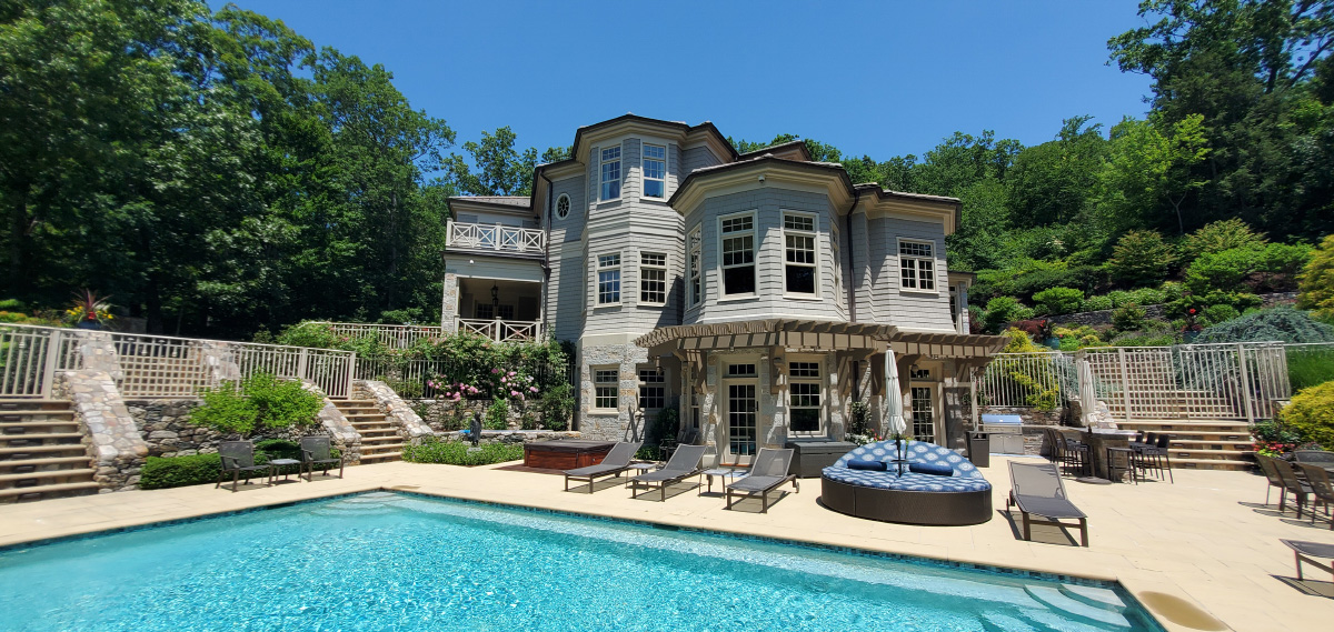 Exterior of painted house, with pool and landing area.