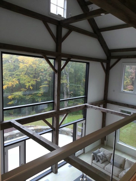 Painted post and beam interior living room from second-story loft.