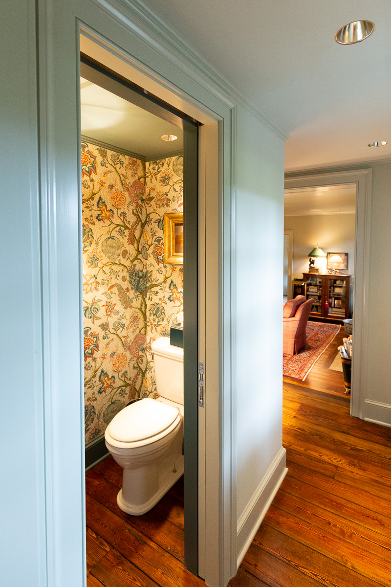 Painted bathroom and hallway with wallpaper.