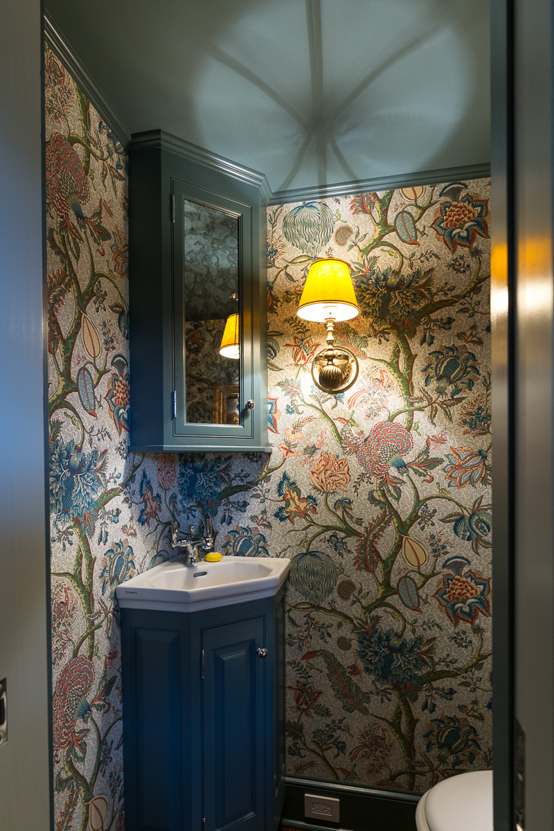 Wallpaper in downstairs bathroom around the vanity.