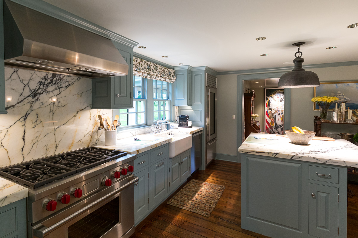 Painting around the kitchen stove and island cabinets.