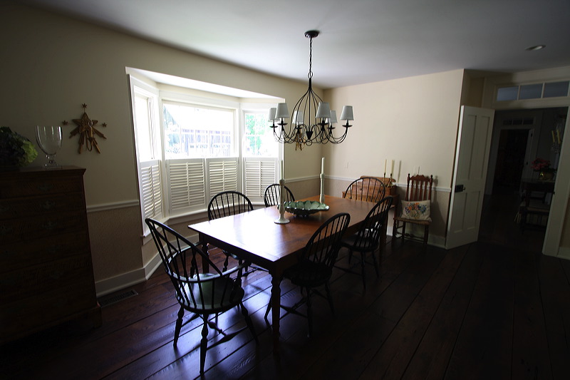 Painted dining room with wooden table.