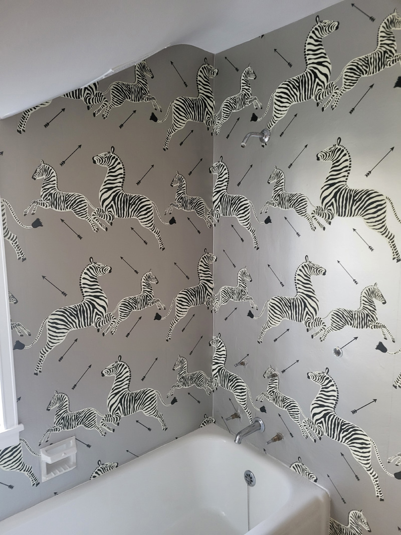 Zebra silver wallpaper around bathroom tub.
