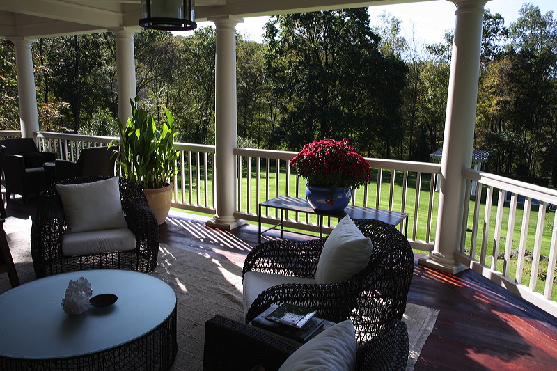 Painted porch, railings and outdoor sitting area of the house.